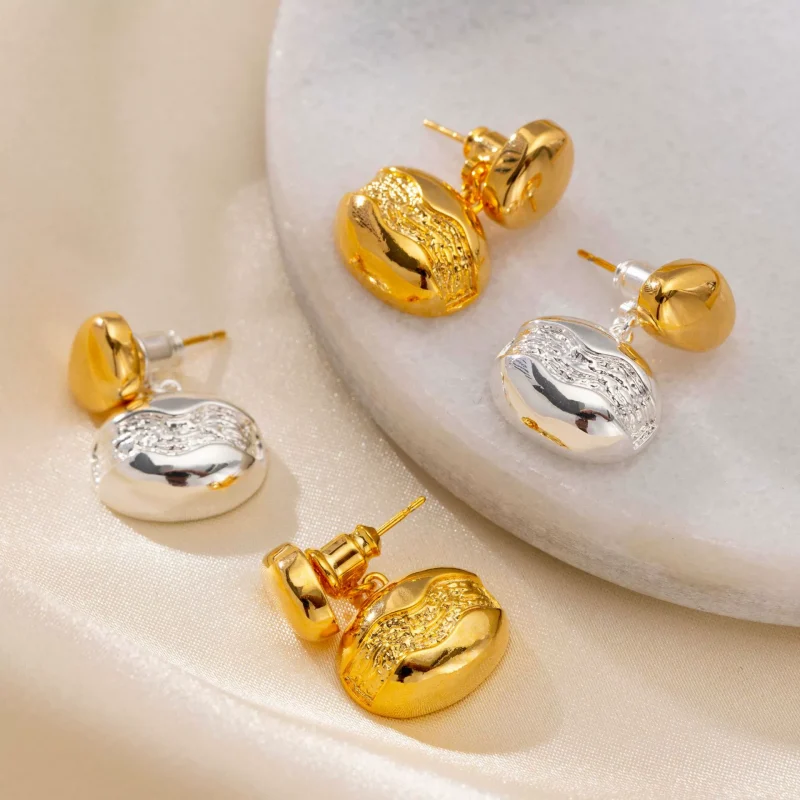 Close-up of brass gold-plated stud earrings showcasing elegant minimalist design.
