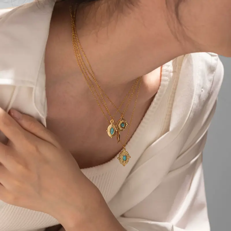 FY’s gold oval bead necklace with intricate vintage texture, styled with a black evening gown for royal-inspired elegance.