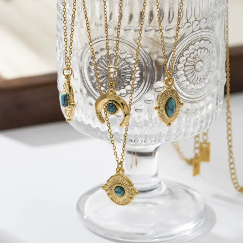 FY’s gold oval bead necklace with intricate vintage texture, styled with a black evening gown for royal-inspired elegance.