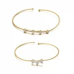 FY’s gold open cuff bracelet with cubic zirconia, styled with a white shirt and watch for modern minimalist elegance.