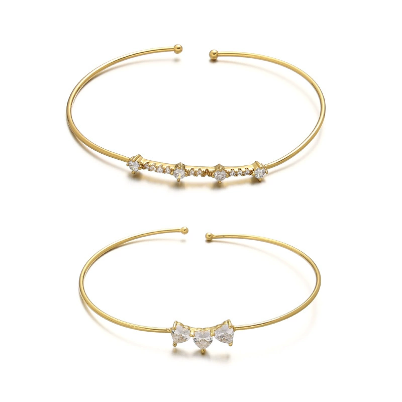 FY’s gold open cuff bracelet with cubic zirconia, styled with a white shirt and watch for modern minimalist elegance.
