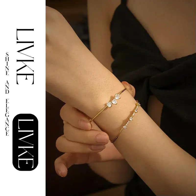 FY’s gold open cuff bracelet with cubic zirconia, styled with a white shirt and watch for modern minimalist elegance.