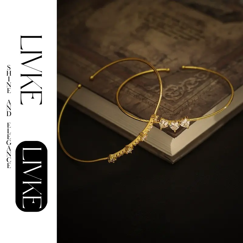 FY’s gold open cuff bracelet with cubic zirconia, styled with a white shirt and watch for modern minimalist elegance.