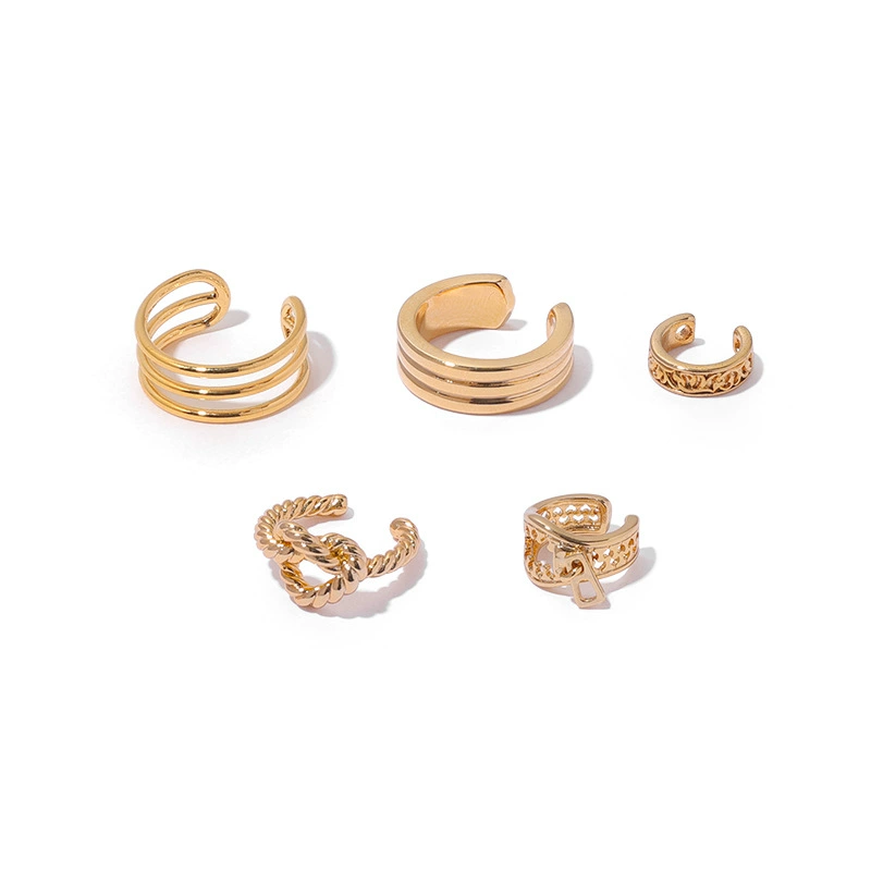 FY’s gold openwork ear cuff styled on a helix, paired with minimalist hoops for edgy everyday elegance.