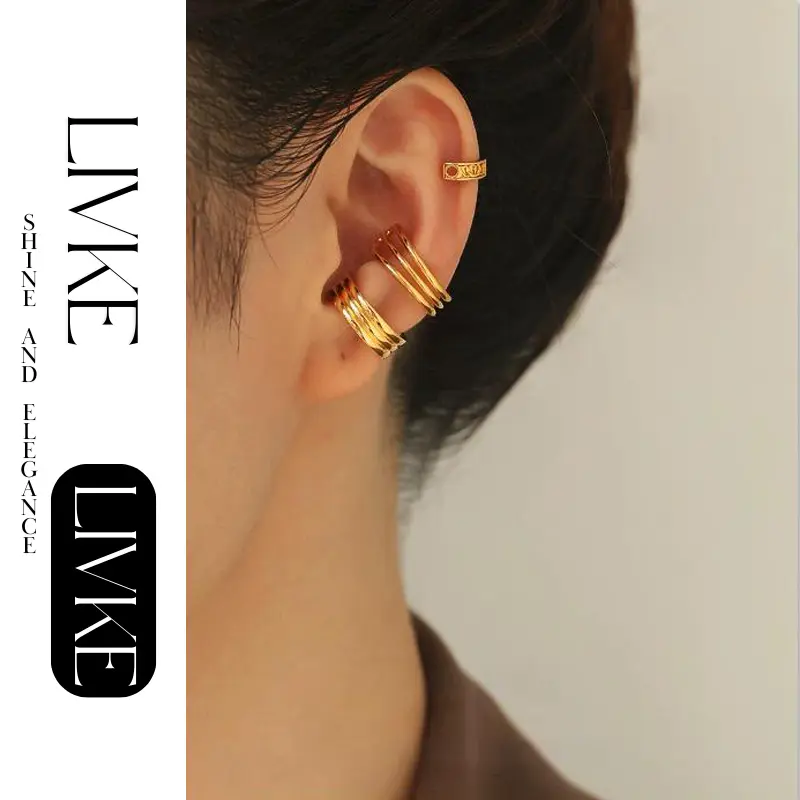 FY’s gold openwork ear cuff styled on a helix, paired with minimalist hoops for edgy everyday elegance.
