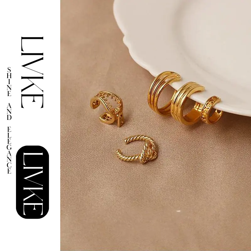 FY’s gold openwork ear cuff styled on a helix, paired with minimalist hoops for edgy everyday elegance.