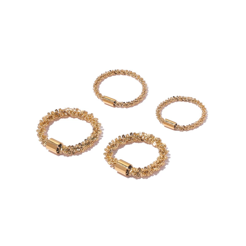 FY’s 18K PVD gold minimalist ring stacked with raw-edge bands for modern gender-neutral style.