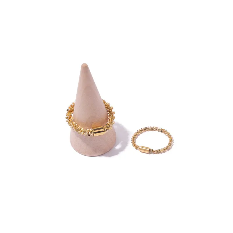 FY’s 18K PVD gold minimalist ring stacked with raw-edge bands for modern gender-neutral style.