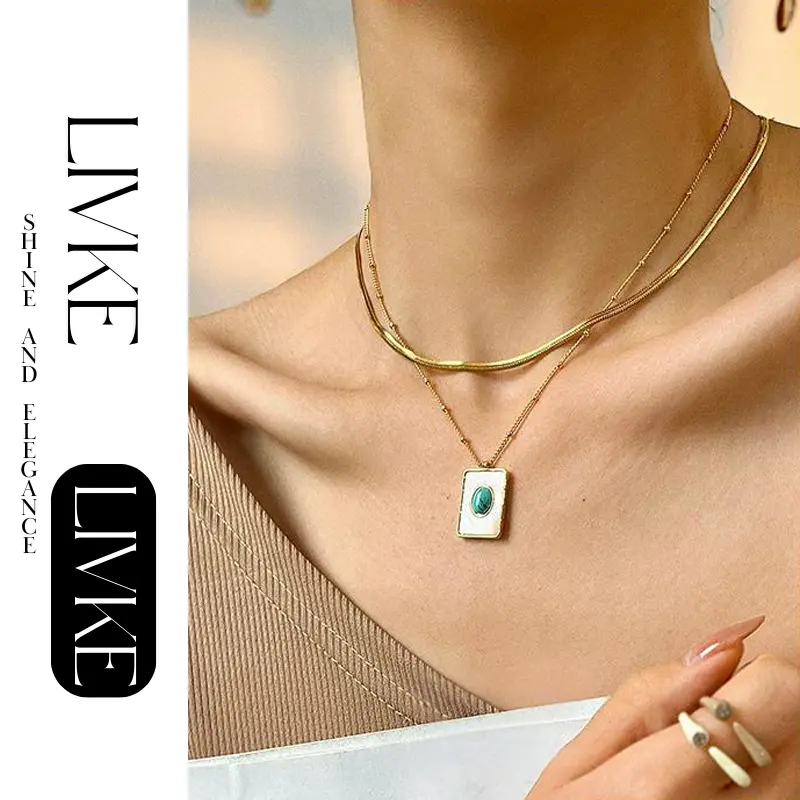 FY’s gold snake chain necklace with shell and turquoise pendant, layered with beaded bracelets for boho summer style.