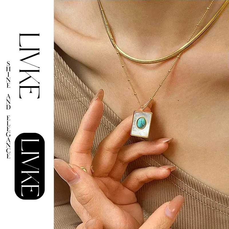 FY’s gold snake chain necklace with shell and turquoise pendant, layered with beaded bracelets for boho summer style.