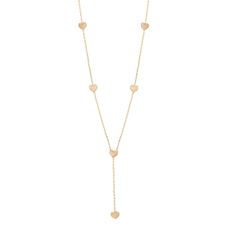 FY’s gold enamel heart pendant necklace styled with a floral dress for Parisian-inspired everyday charm.