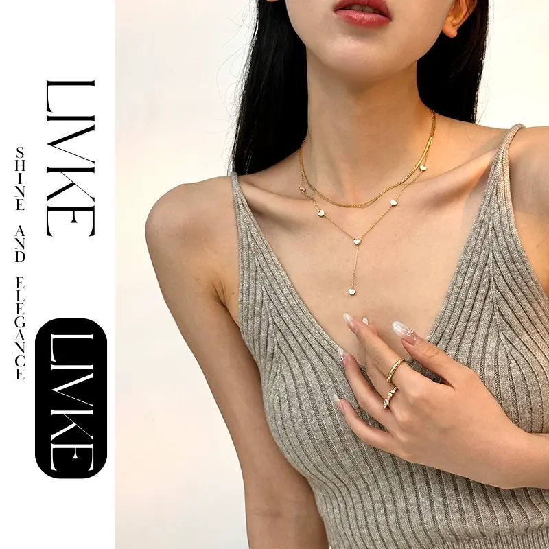 FY’s gold enamel heart pendant necklace styled with a floral dress for Parisian-inspired everyday charm.