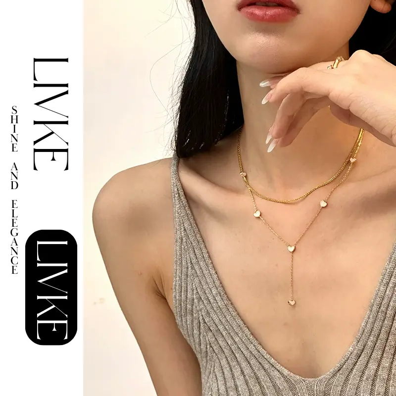 FY’s gold enamel heart pendant necklace styled with a floral dress for Parisian-inspired everyday charm.