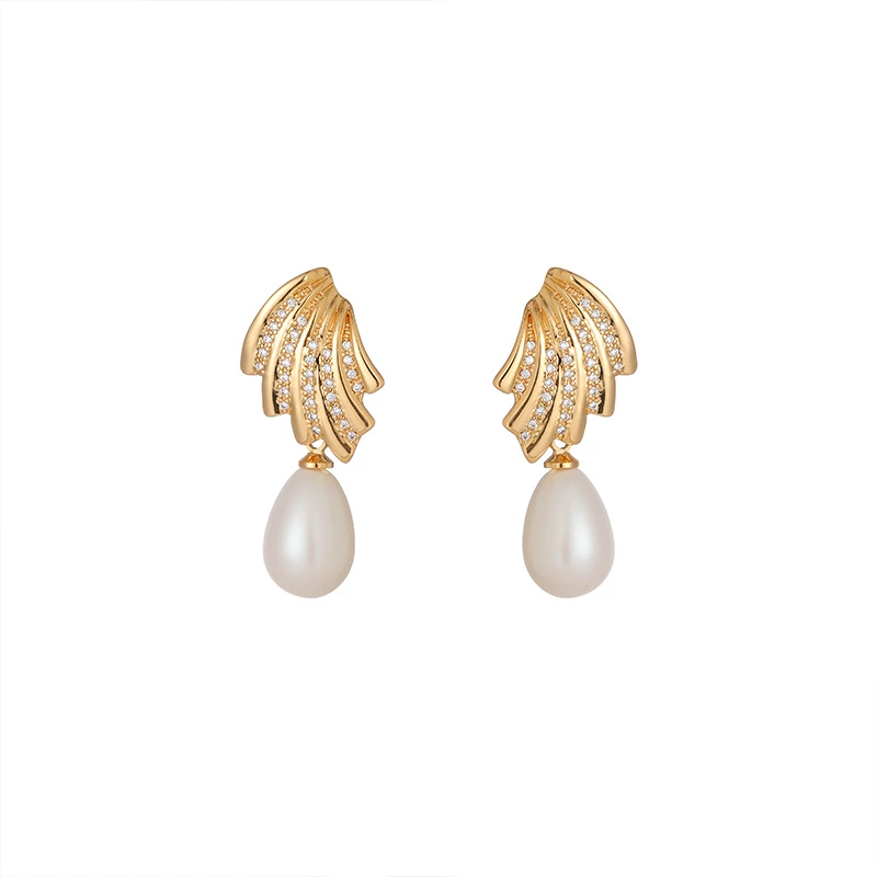FY’s gold vintage pearl drop earrings with zirconia accents, styled with a black dress for Parisian evening elegance.