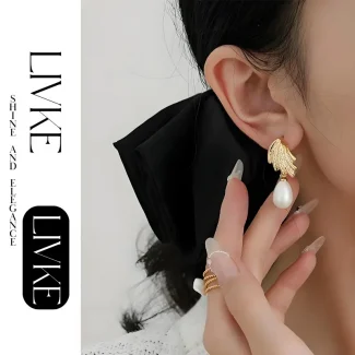 FY’s gold vintage pearl drop earrings with zirconia accents, styled with a black dress for Parisian evening elegance.