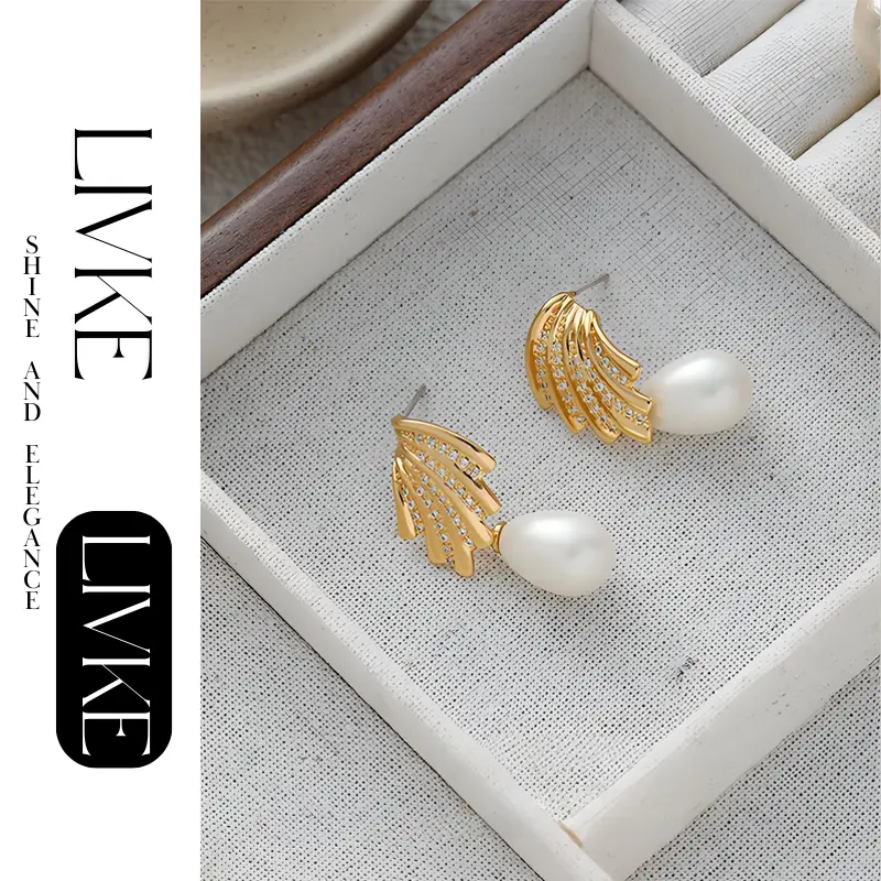FY’s gold vintage pearl drop earrings with zirconia accents, styled with a black dress for Parisian evening elegance.
