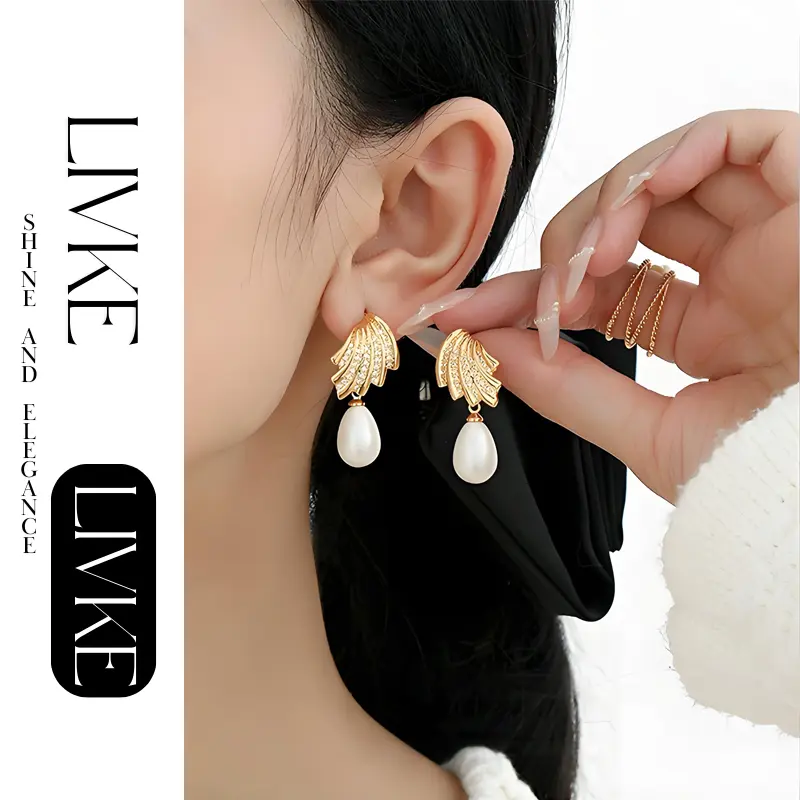 FY’s gold vintage pearl drop earrings with zirconia accents, styled with a black dress for Parisian evening elegance.