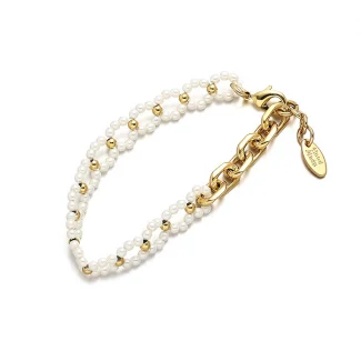 FY’s gold pearl chain bracelet styled on a wrist with a linen sleeve for boho everyday elegance.