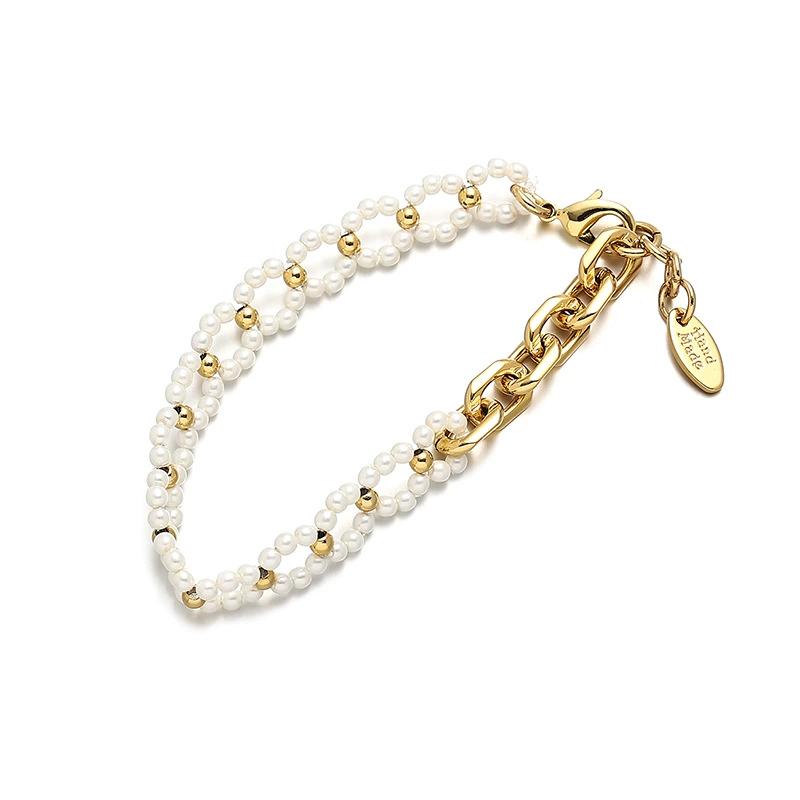 FY’s gold pearl chain bracelet styled on a wrist with a linen sleeve for boho everyday elegance.