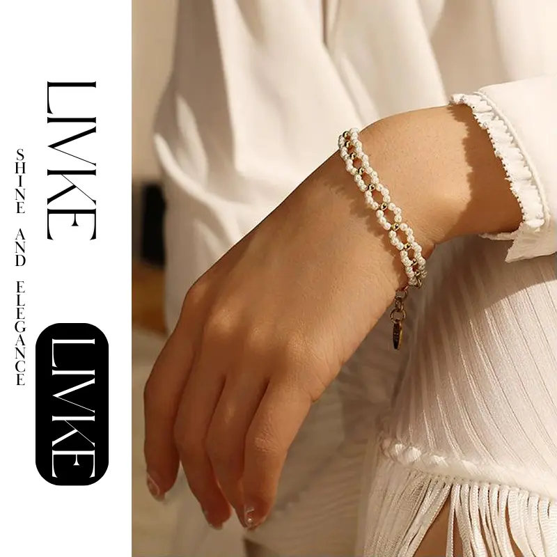 FY’s gold pearl chain bracelet styled on a wrist with a linen sleeve for boho everyday elegance.