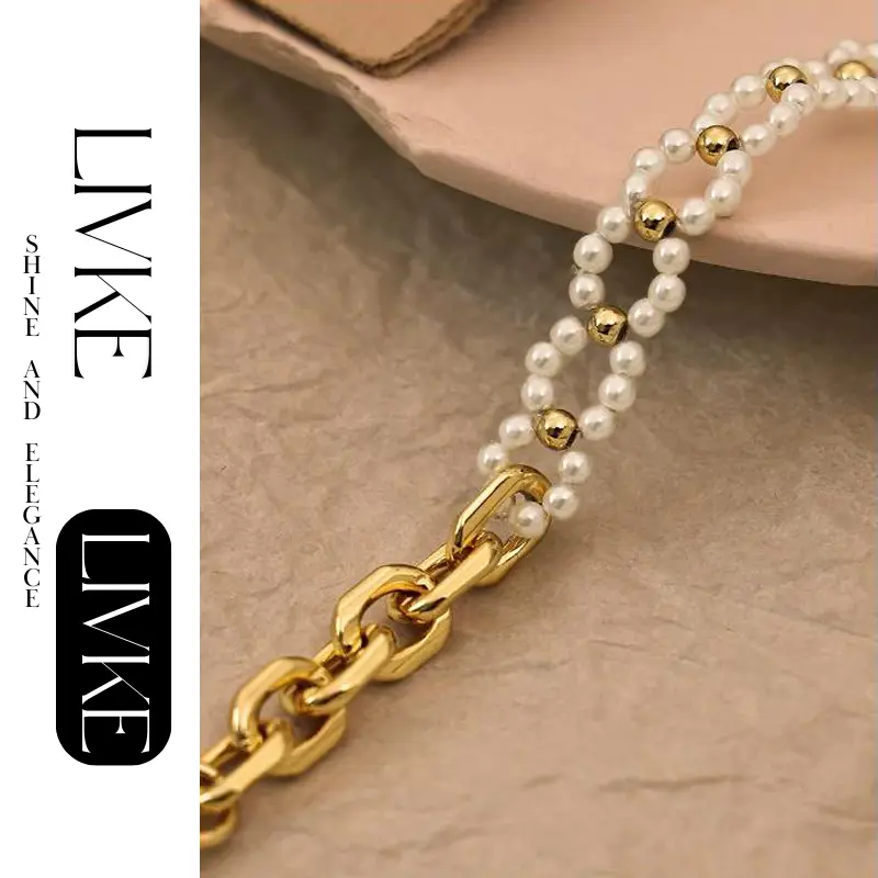 FY’s gold pearl chain bracelet styled on a wrist with a linen sleeve for boho everyday elegance.