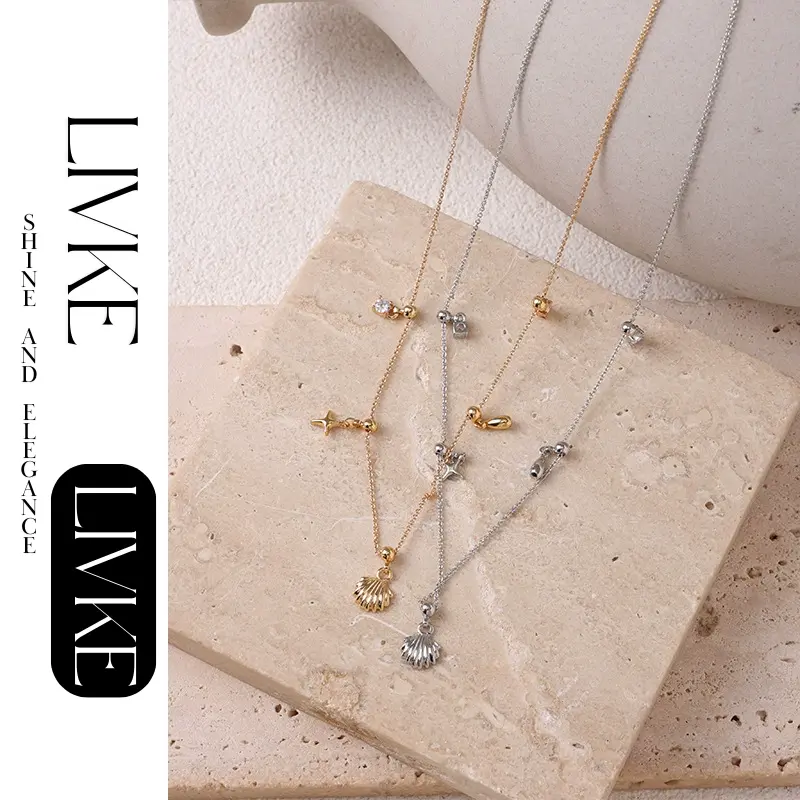 FY’s gold summer wave necklace with shell and zirconia pendant, styled with a straw hat for beachside elegance.