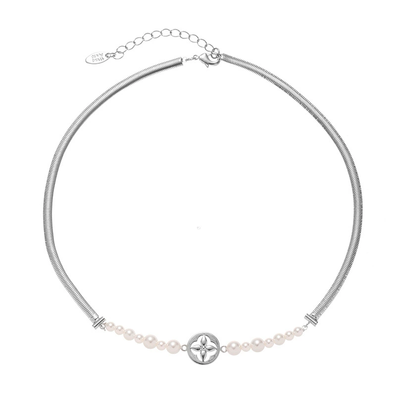 FY’s gold tulip pendant necklace with faux pearl, styled with a trench coat for transitional elegance.