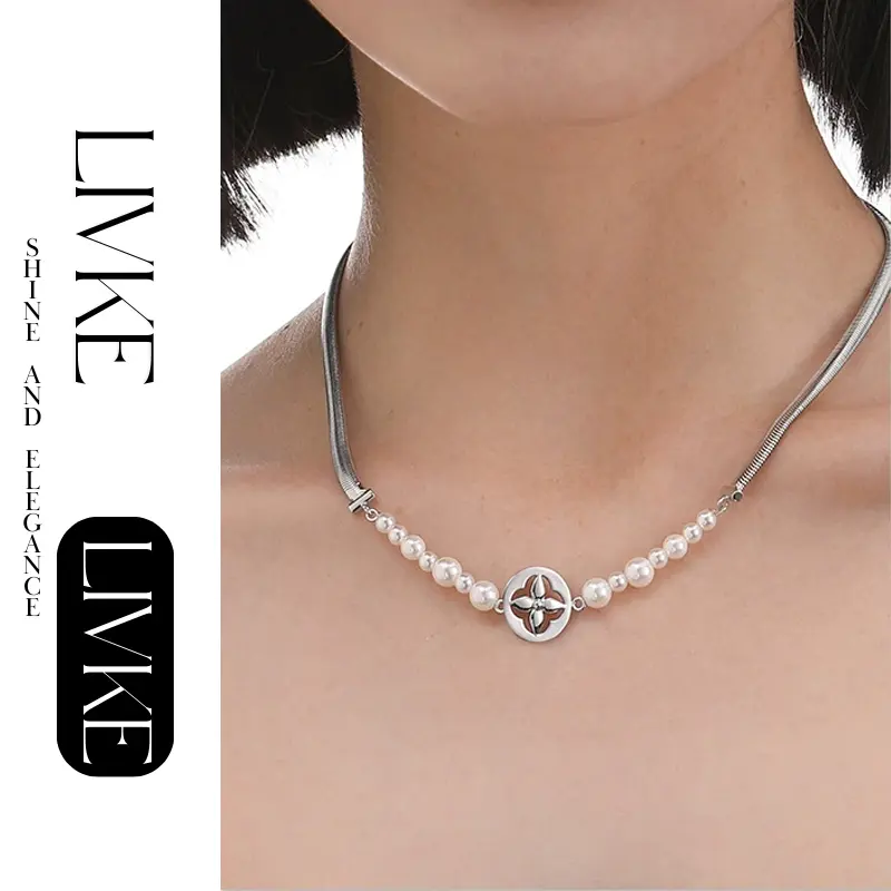 FY’s gold tulip pendant necklace with faux pearl, styled with a trench coat for transitional elegance.