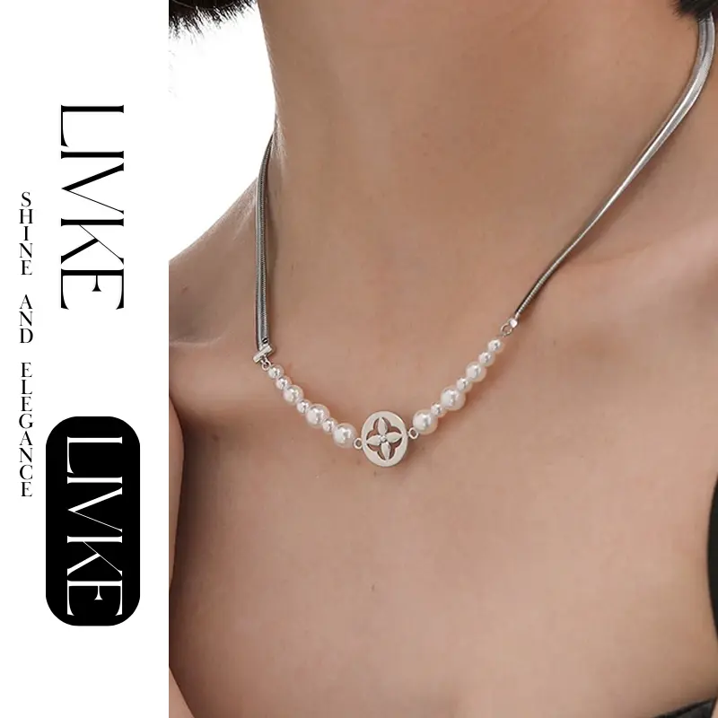 FY’s gold tulip pendant necklace with faux pearl, styled with a trench coat for transitional elegance.