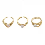 FY’s gold leaf and pearl adjustable ring on a hand with neutral nails, styled with a linen dress for effortless boho elegance.