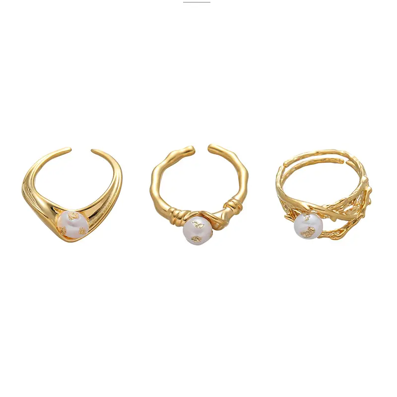 FY’s gold leaf and pearl adjustable ring on a hand with neutral nails, styled with a linen dress for effortless boho elegance.