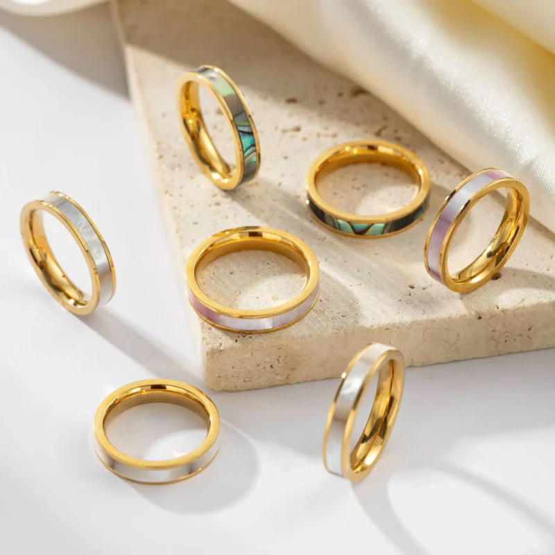 FY 18K gold-plated mother-of-pearl rings in three colors (white/pink/grey) stacked on finger with minimalist outfits