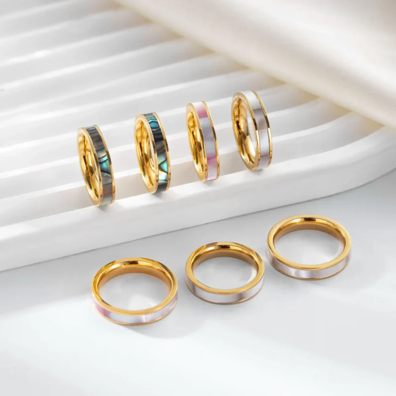 FY 18K gold-plated mother-of-pearl rings in three colors (white/pink/grey) stacked on finger with minimalist outfits