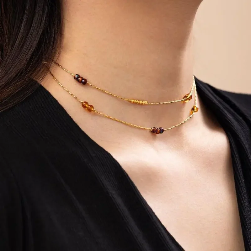 FY gold-plated adjustable tri-bead necklace styled as double layers with minimalist pendants, showing day-to-night versatility