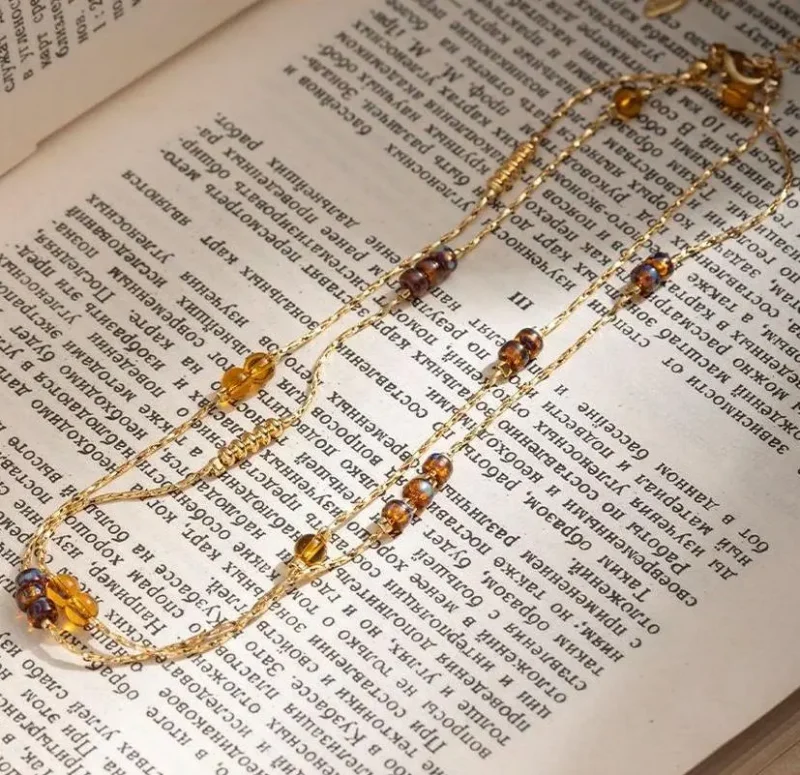 FY gold-plated adjustable tri-bead necklace styled as double layers with minimalist pendants, showing day-to-night versatility