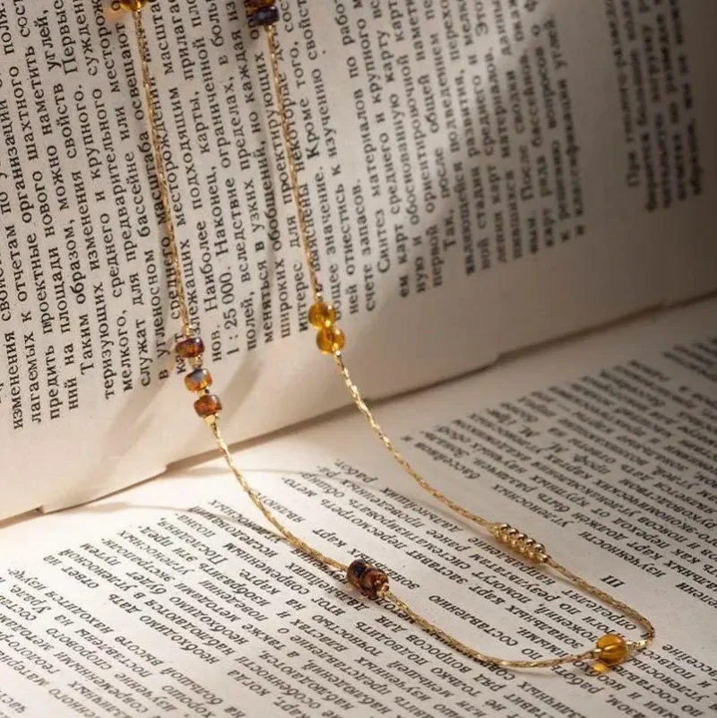 FY gold-plated adjustable tri-bead necklace styled as double layers with minimalist pendants, showing day-to-night versatility