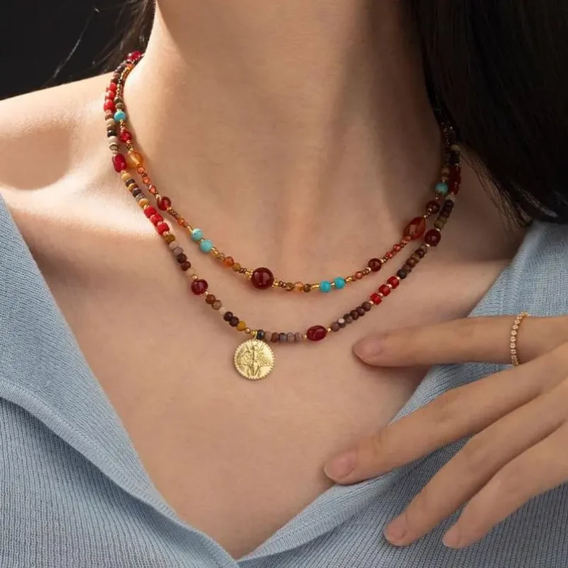 FY surgical steel necklace with red agate and turquoise beads, layered with minimalist chains for boho-chic styling