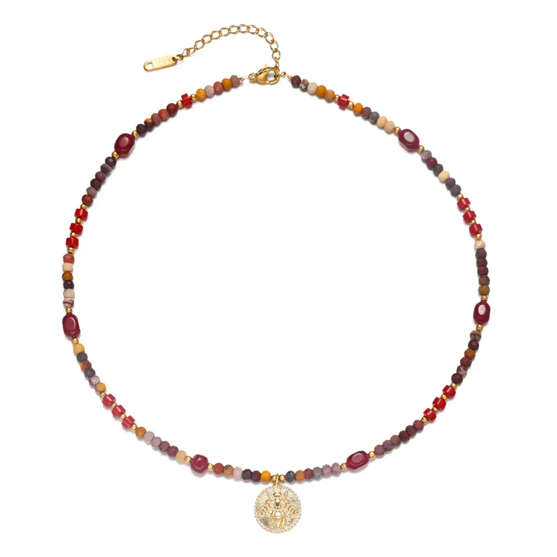FY surgical steel necklace with red agate and turquoise beads, layered with minimalist chains for boho-chic styling