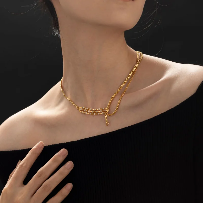 FY gold-plated adjustable chain necklace with cubic zirconia stones, layered with minimal pendants for everyday jewelry styling