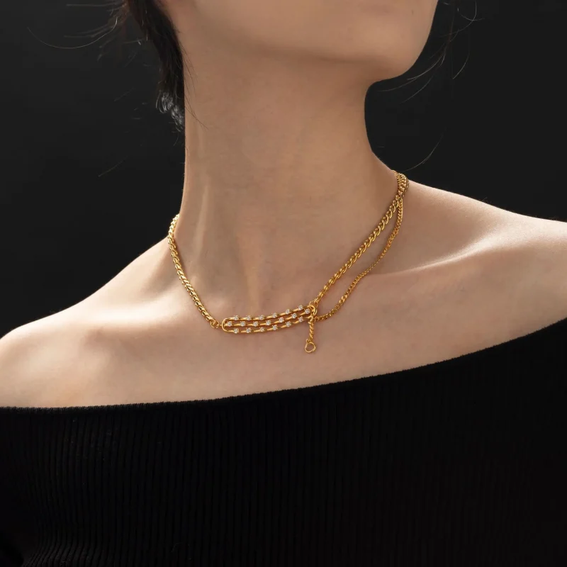 FY gold-plated adjustable chain necklace with cubic zirconia stones, layered with minimal pendants for everyday jewelry styling