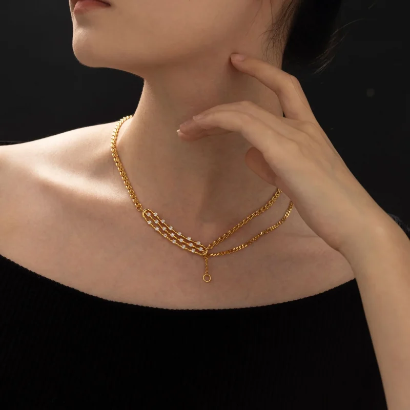 FY gold-plated adjustable chain necklace with cubic zirconia stones, layered with minimal pendants for everyday jewelry styling