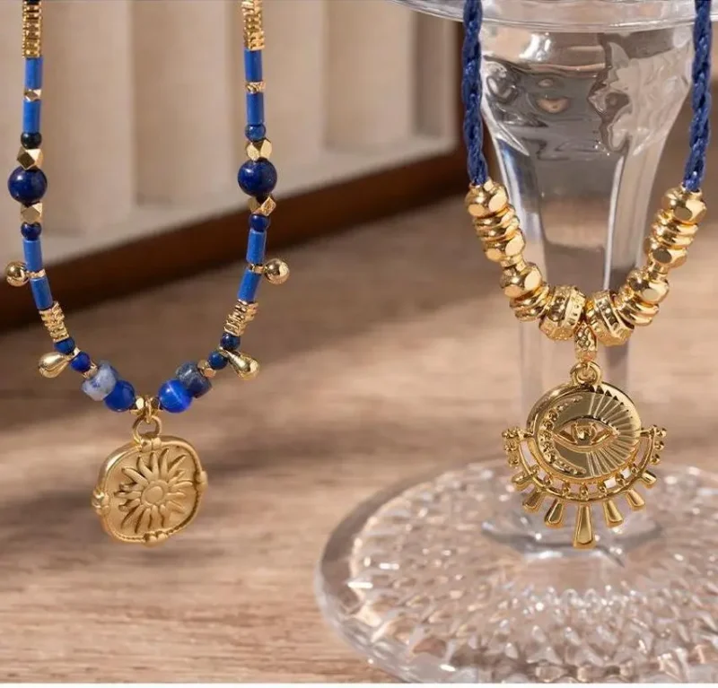 FY’s gold-plated brass necklace featuring a lapis lazuli pendant, styled with a white linen blouse for effortless elegance.